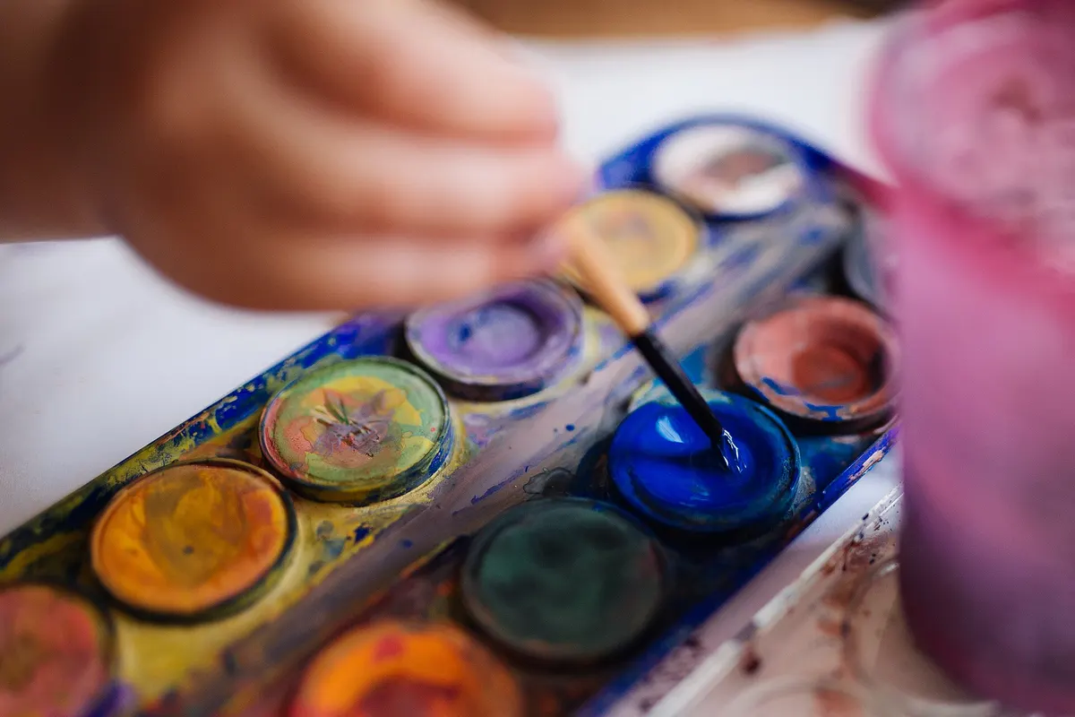 A small hand painting from a palette of watercolour paints